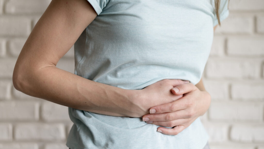 woman having cramps indoors